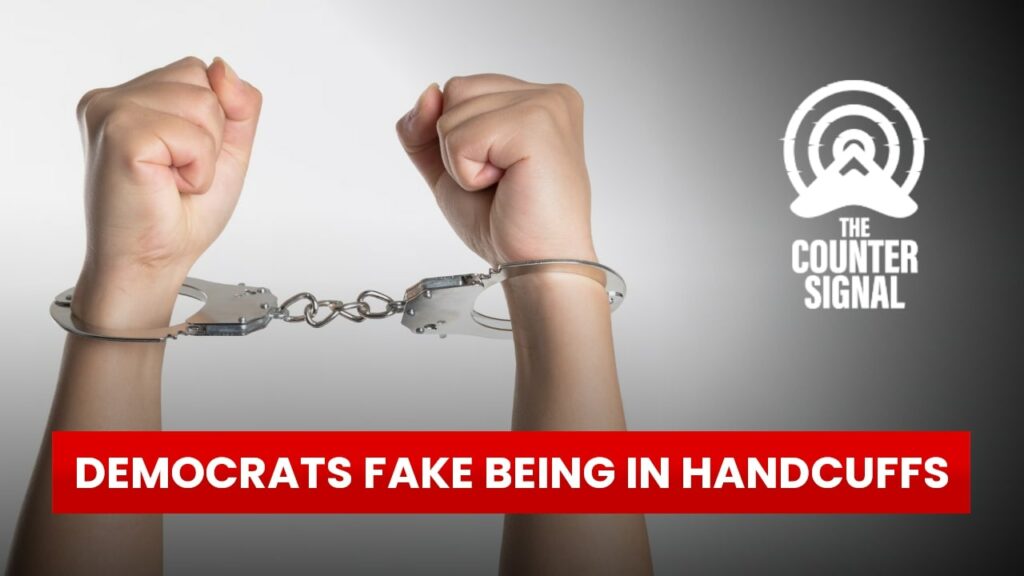 Democrats fake being in handcuffs