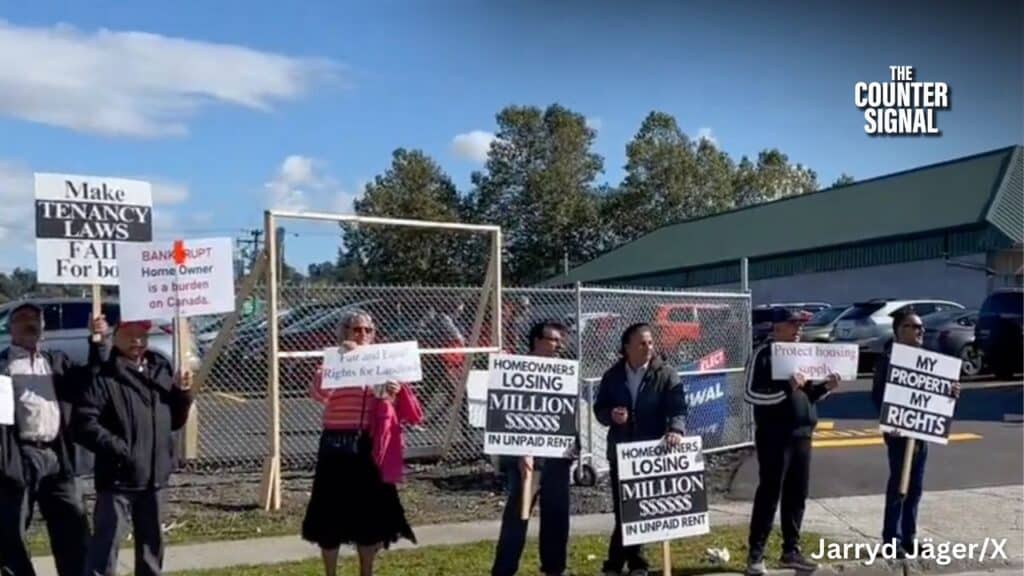 Image of protesters holding signs at the BC NDP campaign stop